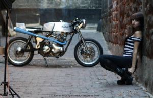 aMortoecycleAndAModelInAnAlley – By&nbsp;Andor